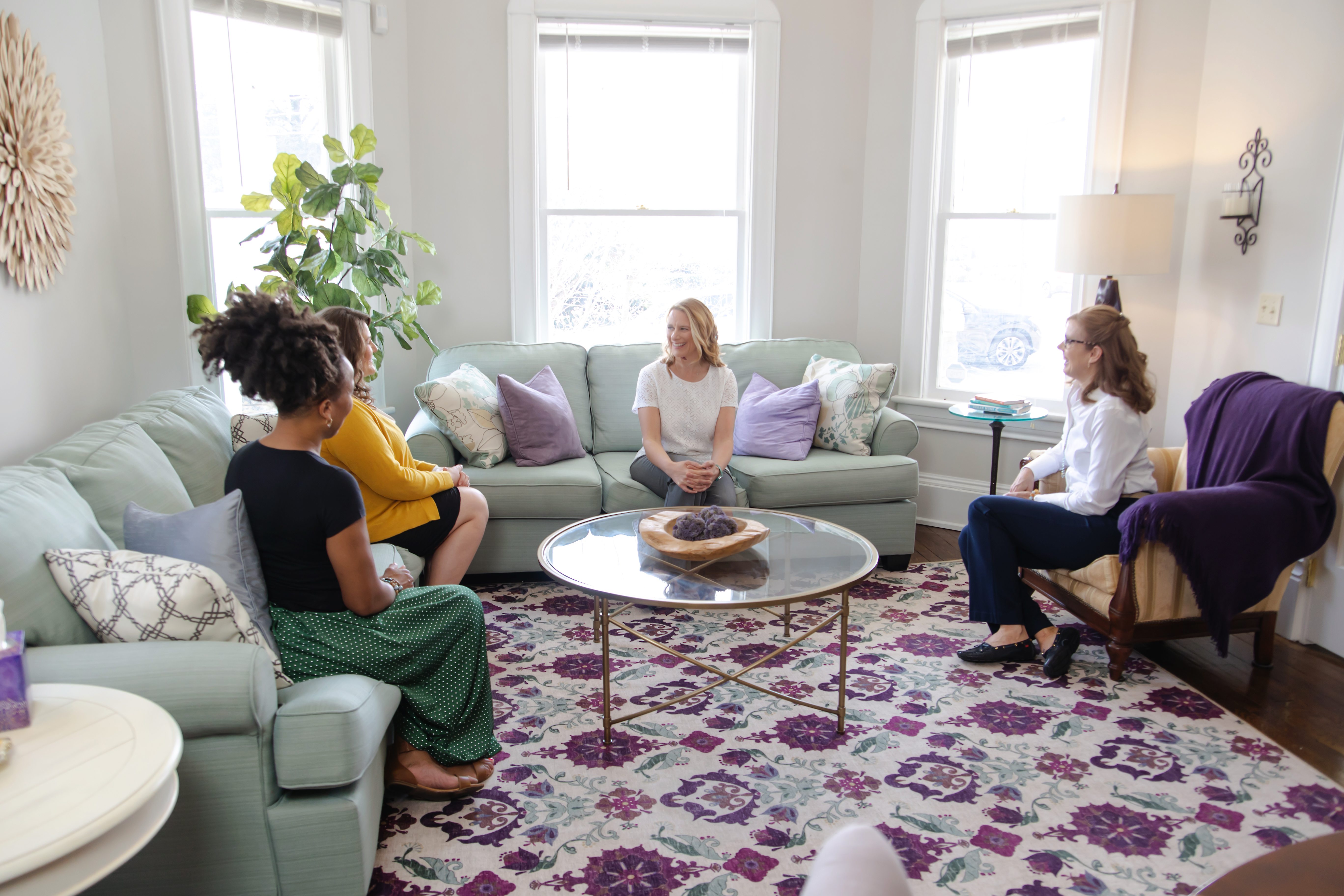 Dr. Christy Arthur in large peaceful meeting room conducting group coaching with patients.